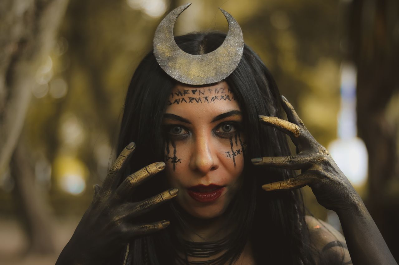 Crafting Captivating Headlines: Your awesome post title goes here Woman with moon headpiece and mystical makeup in an outdoor forest setting.
